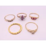 Four 9 ct gold rings and a silver gilt ring. 9.2 grammes total weight.