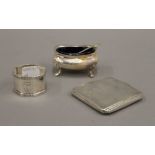 A silver compact, a silver salt and a silver napkin ring. 156.4 grammes.