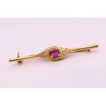 An 18 ct gold ruby and diamond bar brooch. 4.75 cm long. 3.5 grammes total weight.