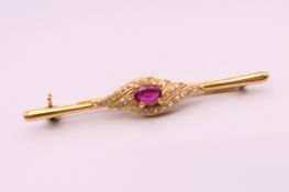 An 18 ct gold ruby and diamond bar brooch. 4.75 cm long. 3.5 grammes total weight.