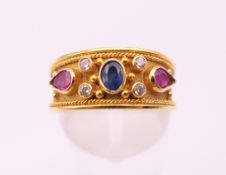 A 14 ct gold diamond, sapphire and ruby byzantine style ring. Ring size O. 4.1 grammes total weight.