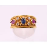 A 14 ct gold diamond, sapphire and ruby byzantine style ring. Ring size O. 4.1 grammes total weight.