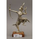 A white metal figure of Rama mounted on a wooden base. 25.5 cm high overall.