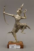 A white metal figure of Rama mounted on a wooden base. 25.5 cm high overall.