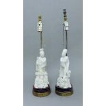 A pair of Chinese blanc de chine figural lamps. The largest 55 cm high overall.