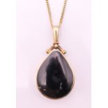 A 9 ct gold, abalone and onyx pendant on a 9 ct gold chain. Pendant 4.