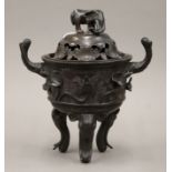 A Chinese bronze censer with elephant finial, and elephant mask twin handles and feet. 25 cm high.