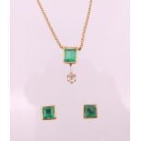 A 9 ct gold, emerald and diamond pendant necklace with matching earrings. Pendant 1.