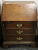 A Georgian oak bureau of small proportions. 61 cm wide x 86 cm high.