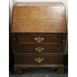 A Georgian oak bureau of small proportions. 61 cm wide x 86 cm high.