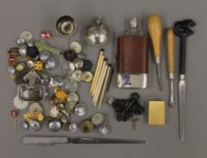 A display tray of vintage collectable's, including a quantity of uniform buttons, badges and pins,