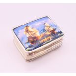 A silver pill box depicting ships. 3.25 x 2.5 cm.