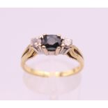 An 18 ct gold diamond and sapphire ring. Ring size N/O. 3.5 grammes total weight.