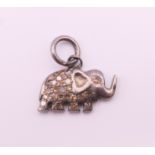 A diamond set elephant form charm. 1.5 cm long.