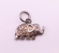 A diamond set elephant form charm. 1.5 cm long.