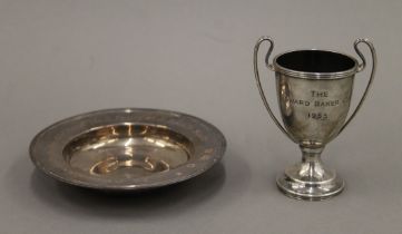 A silver ashtray and a small silver trophy. The former 12 cm diameter. 190.5 grammes.