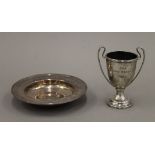 A silver ashtray and a small silver trophy. The former 12 cm diameter. 190.5 grammes.