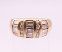 A 14 ct gold ring with twelve baguette and eight brilliant cut diamonds. Ring size L.