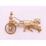 A diamond set gold brooch formed as a horse and driver. 5 cm wide. 11.8 grammes total weight.