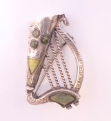 A silver brooch formed as a harp. 3.5 cm high.
