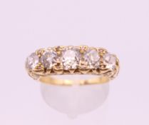 An Edwardian 18 ct gold five stone diamond ring. Total diamond weight approximately 2 carats.