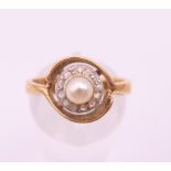 A 14 ct gold diamond and pearl ring. Ring size M.