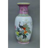 A Chinese porcelain vase decorated with peacocks. 48.5 cm high.