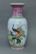 A Chinese porcelain vase decorated with peacocks. 48.5 cm high.