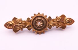 A 15 ct gold and diamond brooch. 4.5 cm long. 3.1 grammes total weight.