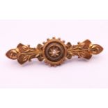 A 15 ct gold and diamond brooch. 4.5 cm long. 3.1 grammes total weight.