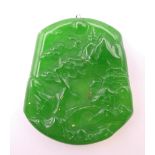 A gold mounted apple green jade pendant. 5.5 cm high.