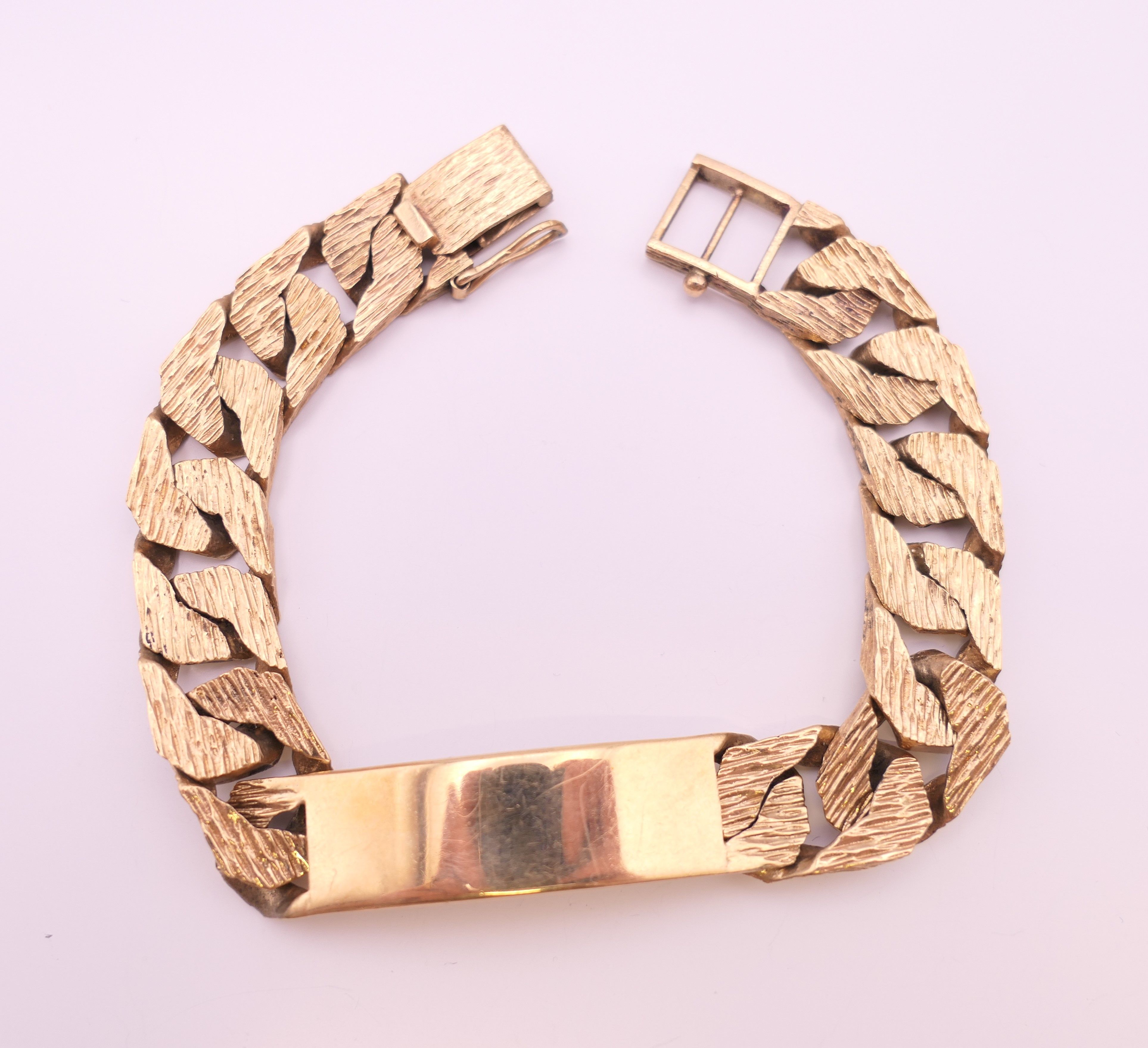 A 9 ct gold identity bracelet. 20 cm long. 60 grammes.