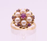 A 9 ct gold ruby and pearl ring. Ring size M.