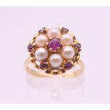 A 9 ct gold ruby and pearl ring. Ring size M.