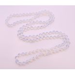 A string of opaline glass beads. 116 cm long.