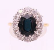 An 18 ct gold and platinum, diamond and sapphire ring. Ring size Q.