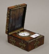 A 19th century brass mounted walnut cased travelling clock. The case 9 cm wide.