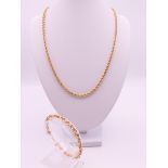 A 9 ct gold rope twist necklace and bracelet. Necklace 50 cm long, bracelet 17.5 cm long. 9.