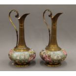 A pair of gilt metal mounted porcelain ewers. 40 cm high.