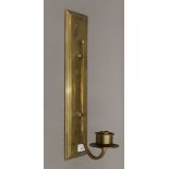 An Arts and Crafts style brass wall hanging candle sconce. 45 cm high.