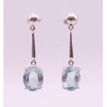 A pair of 18 ct white gold and aquamarine drop earrings. 3.5 cm high overall, aquamarine 1 cm high.