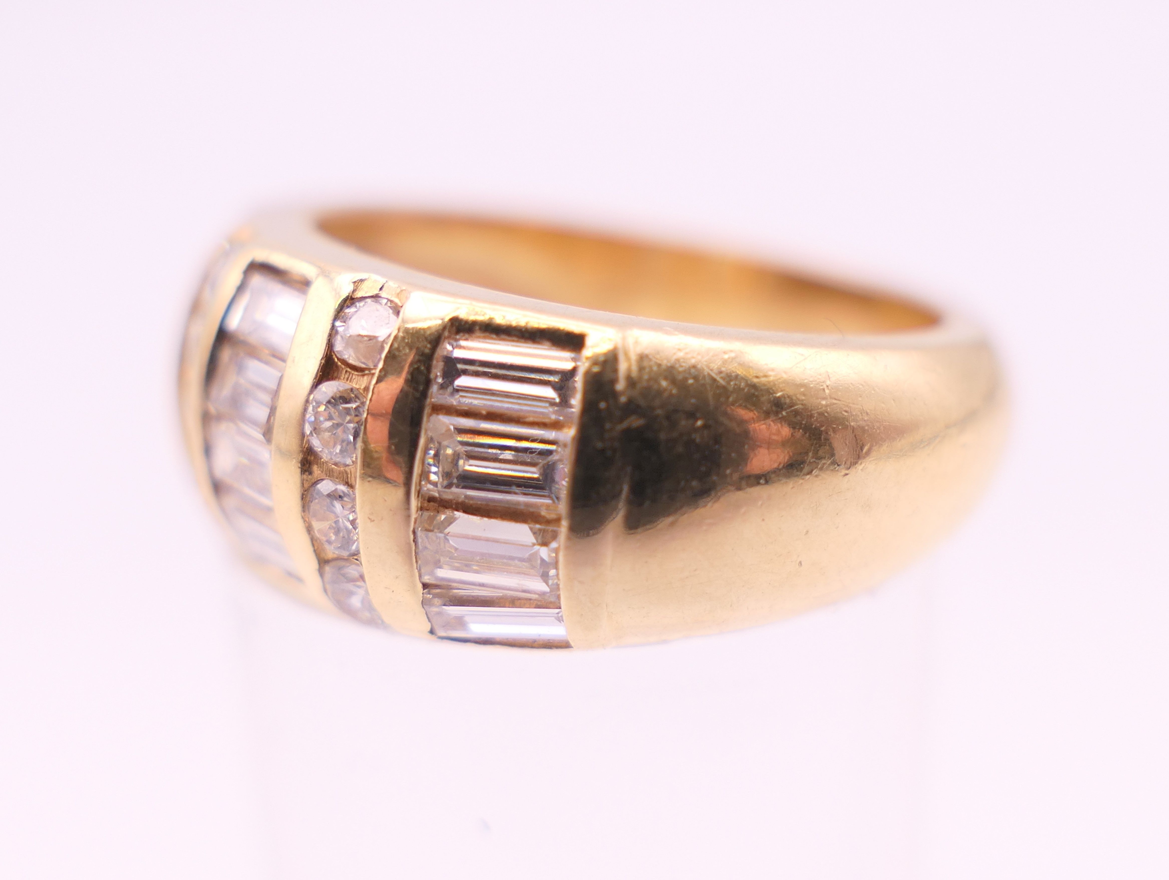 A 14 ct gold ring with twelve baguette and eight brilliant cut diamonds. Ring size L. - Image 3 of 5