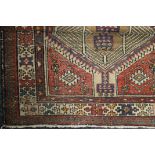 Three vintage red ground rugs.