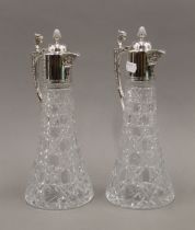 A pair of silver mounted cut glass claret jugs. 30.5 cm high.