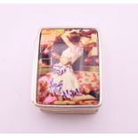 A silver pill box depicting lovers. 3.25 x 2.5 cm.