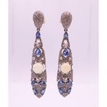 A pair of opal, diamond and sapphire earrings. 5.75 cm high.