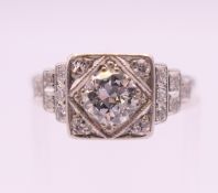 An Art Deco platinum and diamond ring, the central stone approximately .