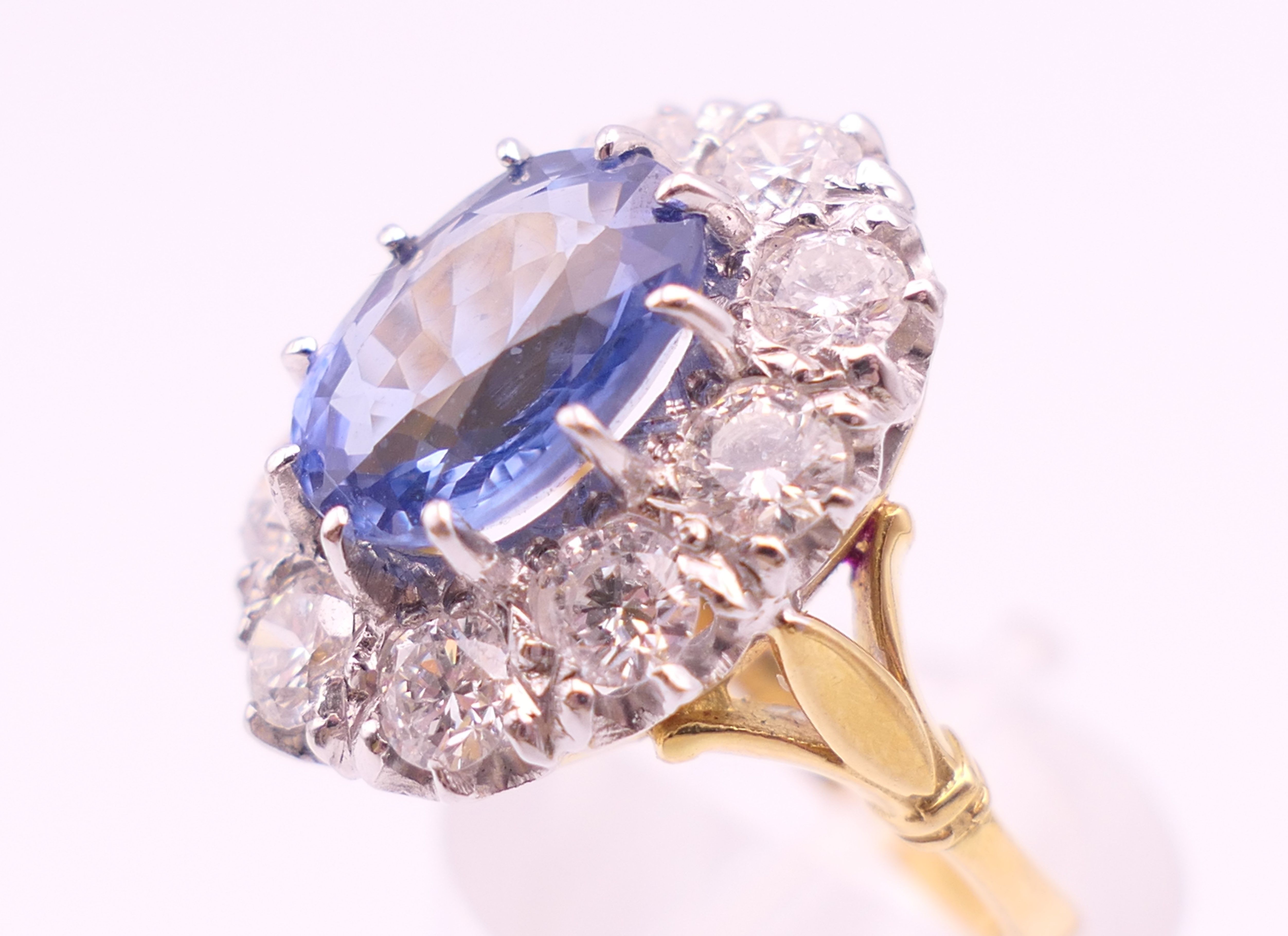 An 18 ct gold and platinum diamond and sapphire ring. - Image 7 of 9
