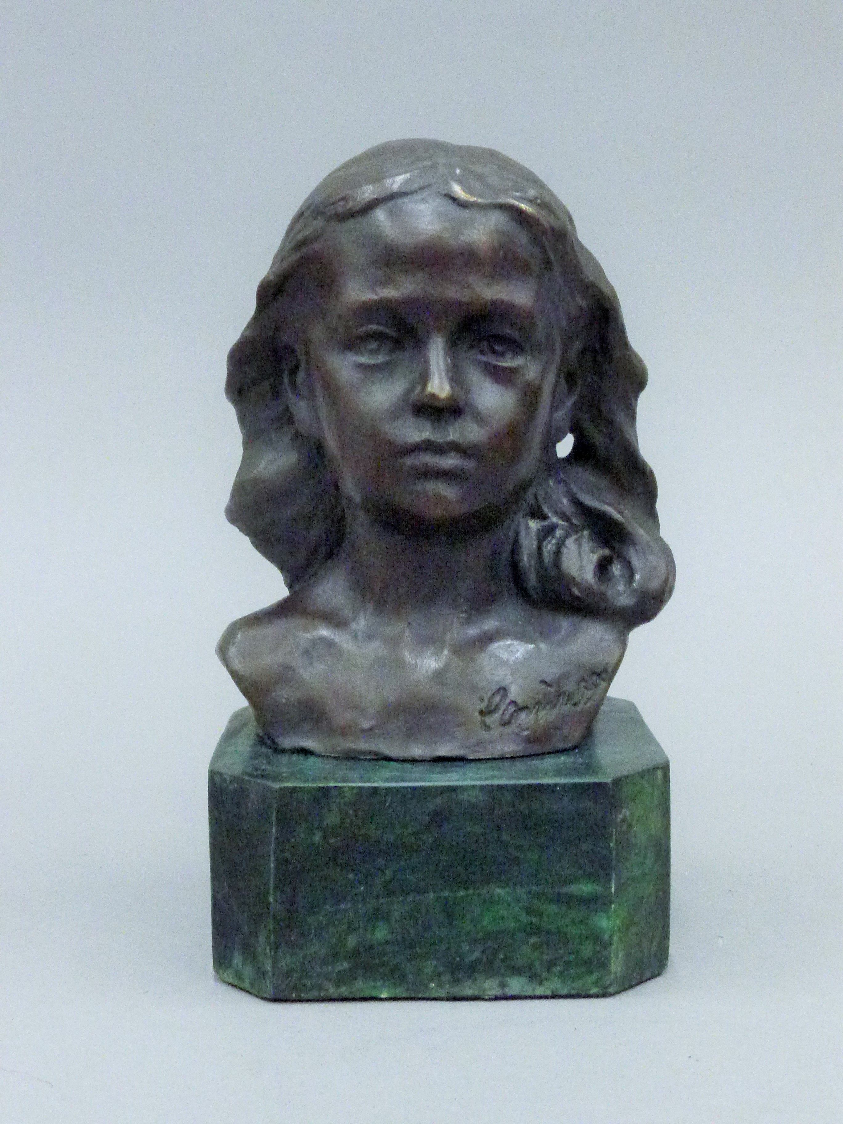 A bronze bust of a young girl on a plinth base. 15 cm high.