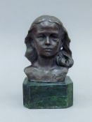 A bronze bust of a young girl on a plinth base. 15 cm high.